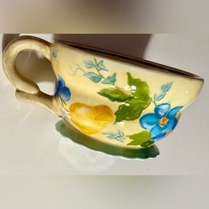 Hand-painted coffee mug by Tracy Porter. featuring yellow & blue floral prints